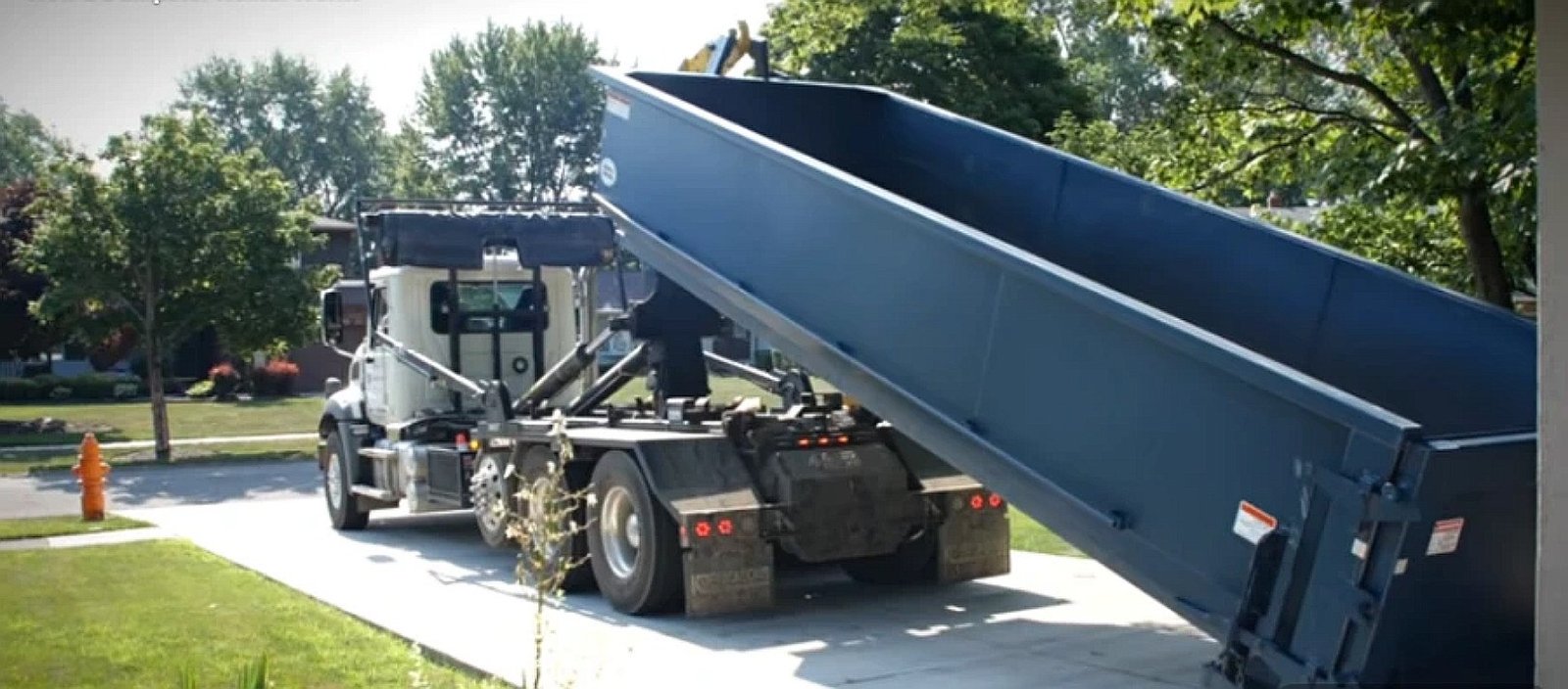 Roll-off truck delivering dumpster in Lubbock TX